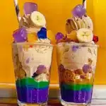 Filipino dessert halo-halo with colorful layers of shaved ice, jackfruit, nata de coco, and ube ice cream